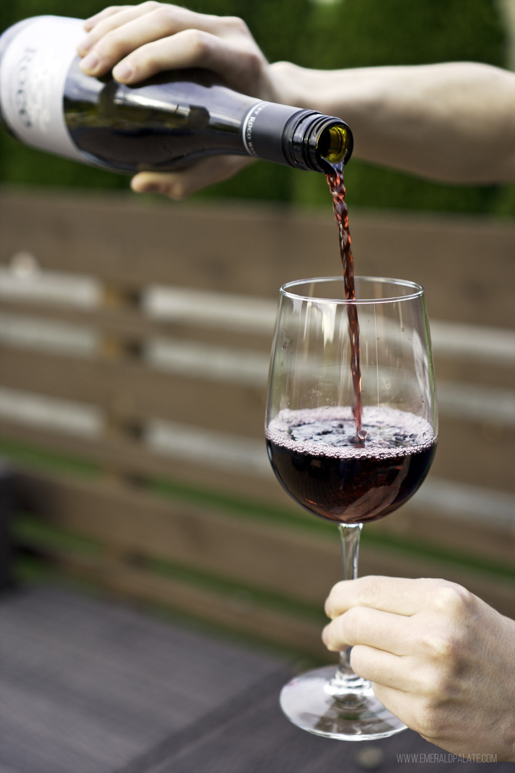 man pouring red wine from one of the best Oregon wines