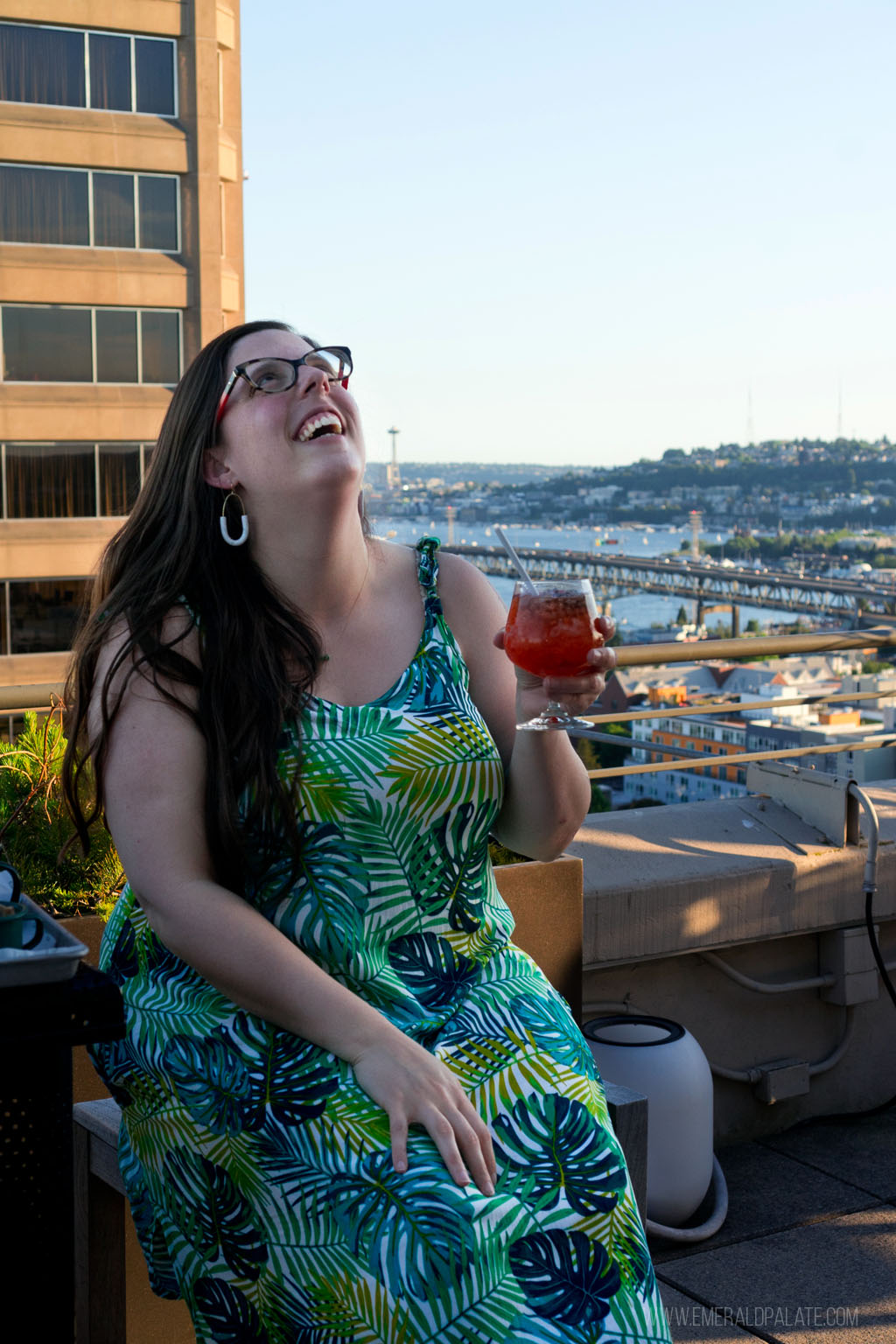 woman laughing with a cocktail from one of the best speakeasy bars in Seattle