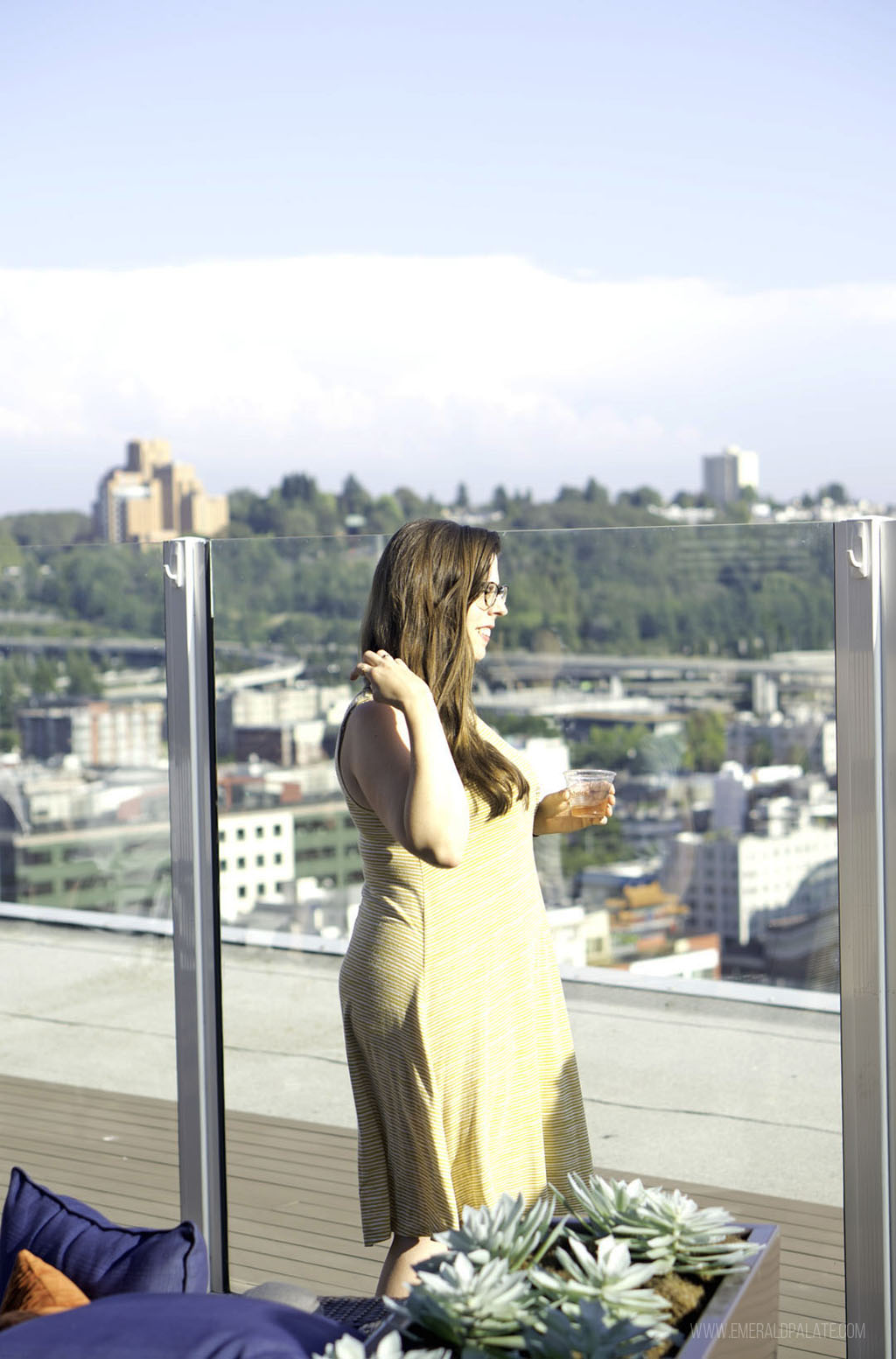 woman drinking on The Smith Tower rooftop bar