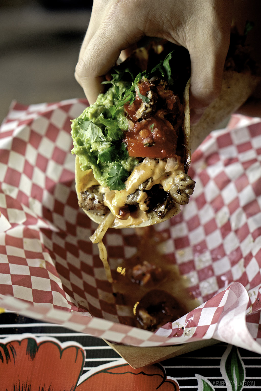person holding a messy carne asada taco at one of the top restaurants in Skagit County, Washington