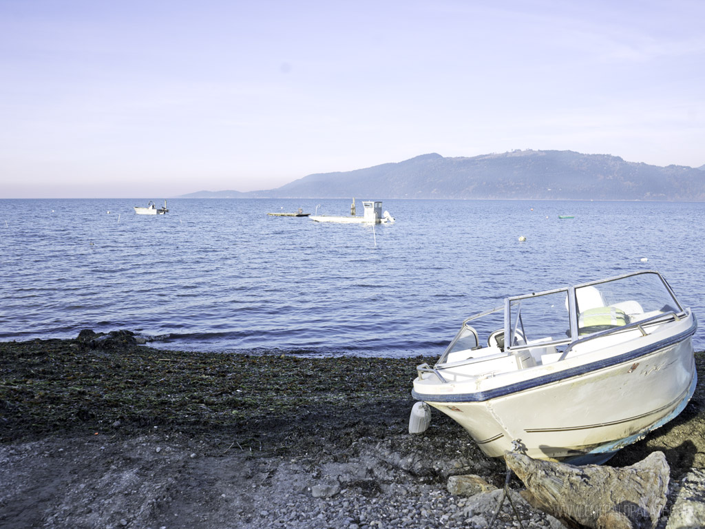 Samish Bay in Skagit County from beach with boat | Best Road Trips from Seattle