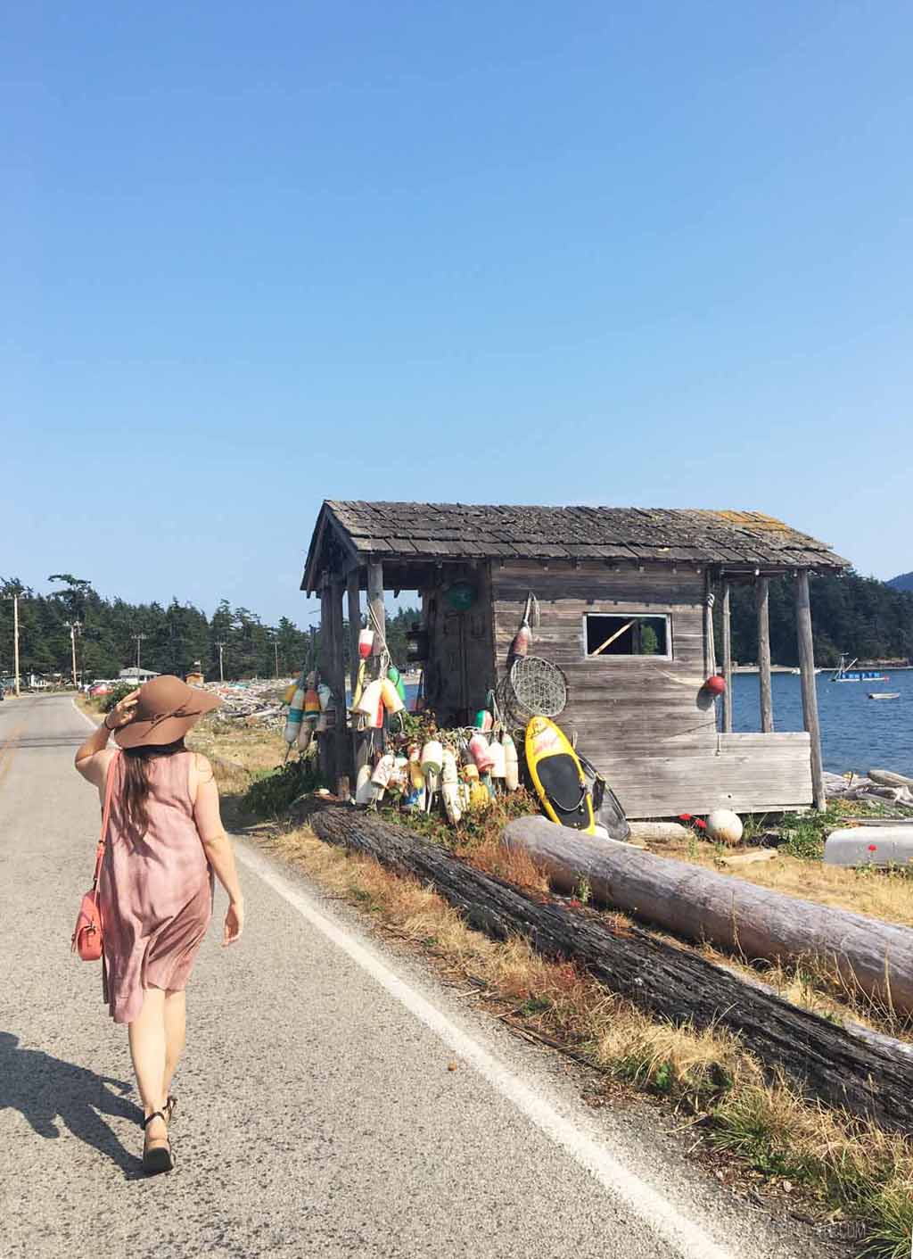 woman walking on street near buoys on Lummi Island