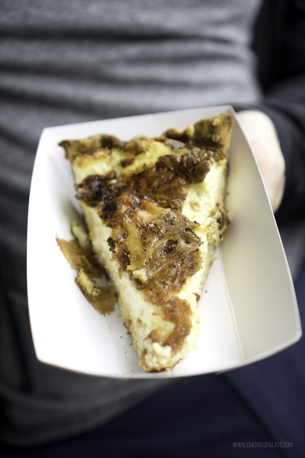 close up of person holding a quiche during a San Juan Island day trip