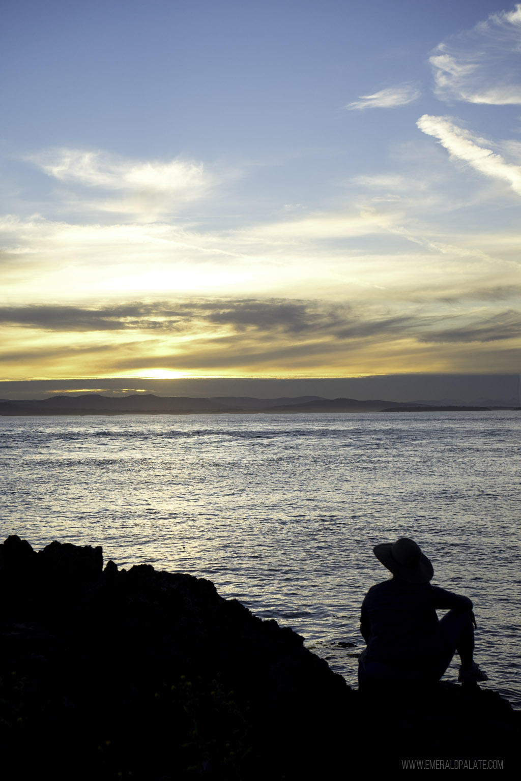 woman overlooking sunset view on water at Lime Kiln Park