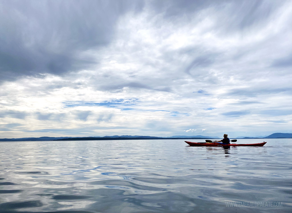 woman kayaking on Salish Sea during a day trip to San Juan Island from Seattle
