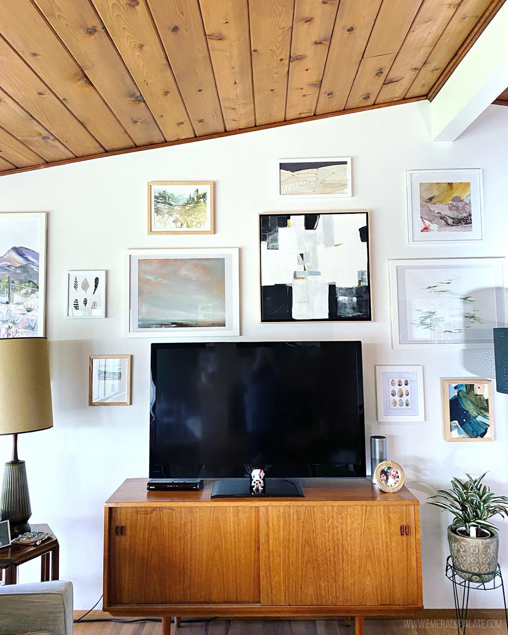 gallery wall behind a TV with affordable Pacific Northwest artists 
