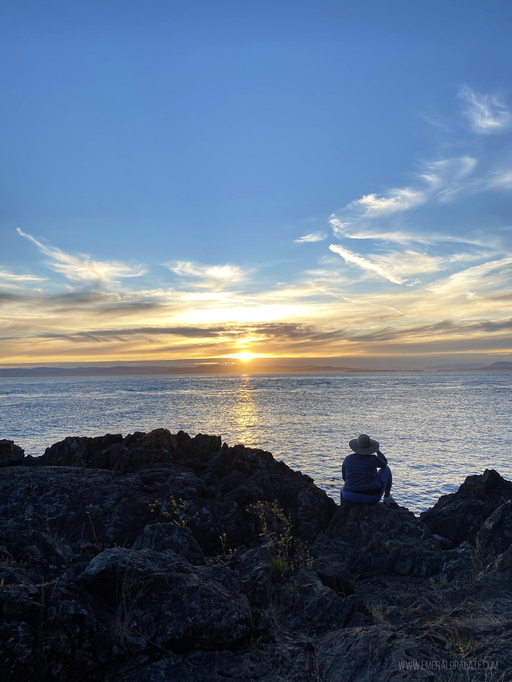 woman overlooking Lime Kiln Park water view at sunset on a San Juan Island day trip