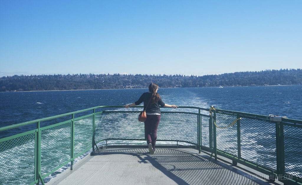 woman on a ferry to one of the best scenic day trips from Seattle
