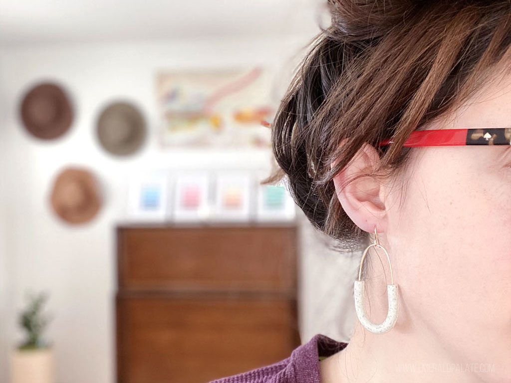 Woman wearing polymer clay hoop earrings from a gift shop in Seattle