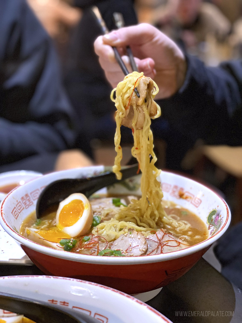 person lifting up noodles from a ramen bowl in Whistler