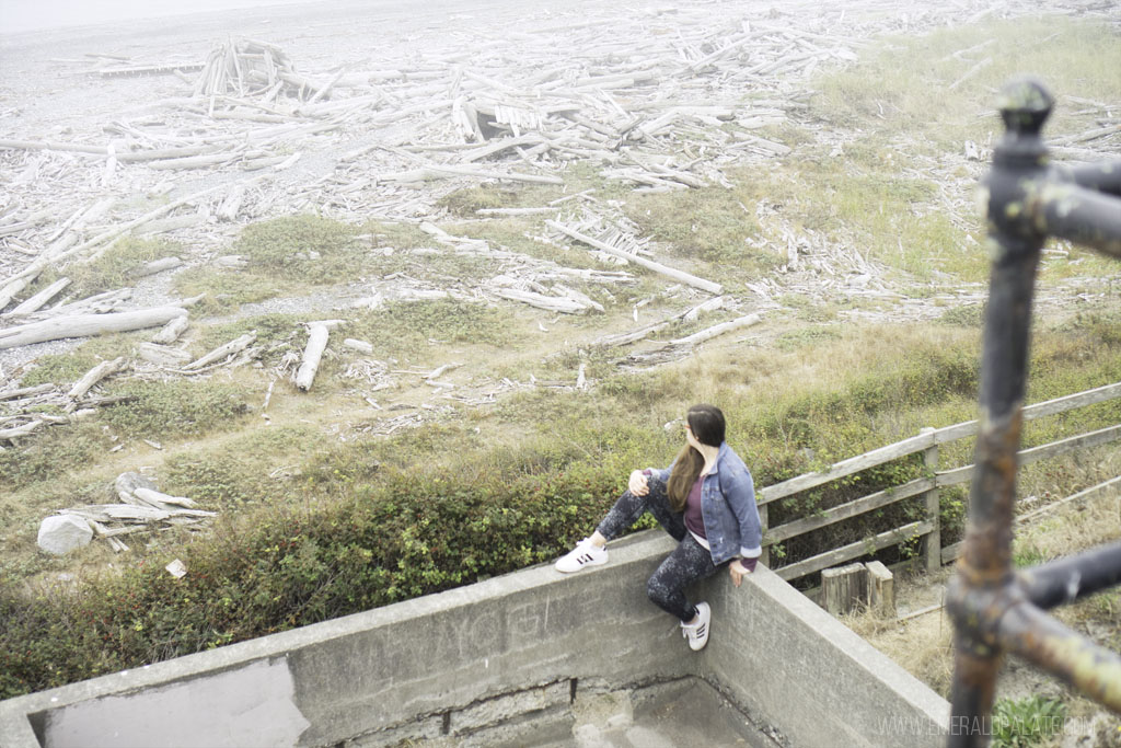 woman sitting on fort wall overlooking beach at Fort Casey State Park on Whidbey Island