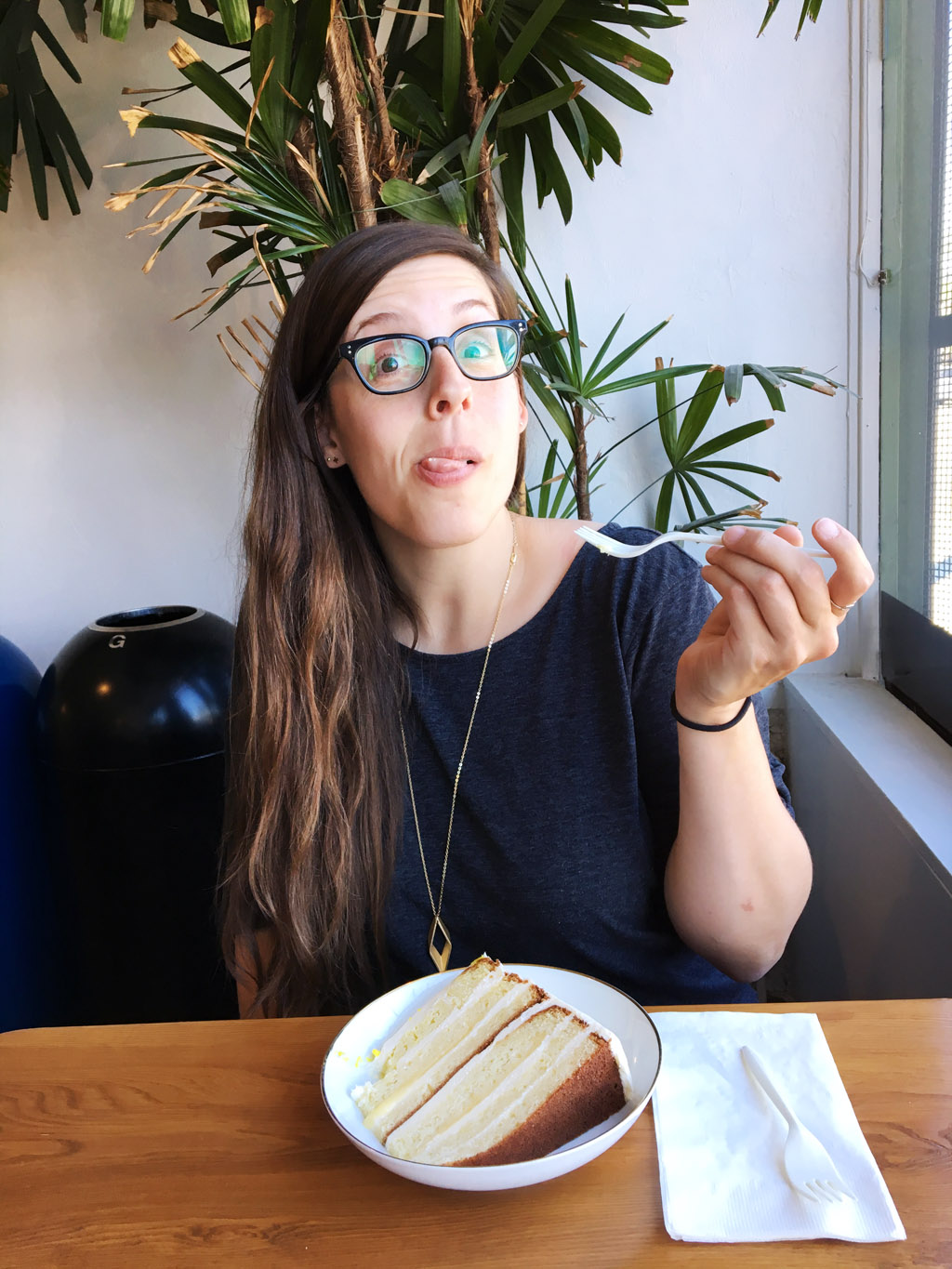 owner of The Emerald Palate eating cake