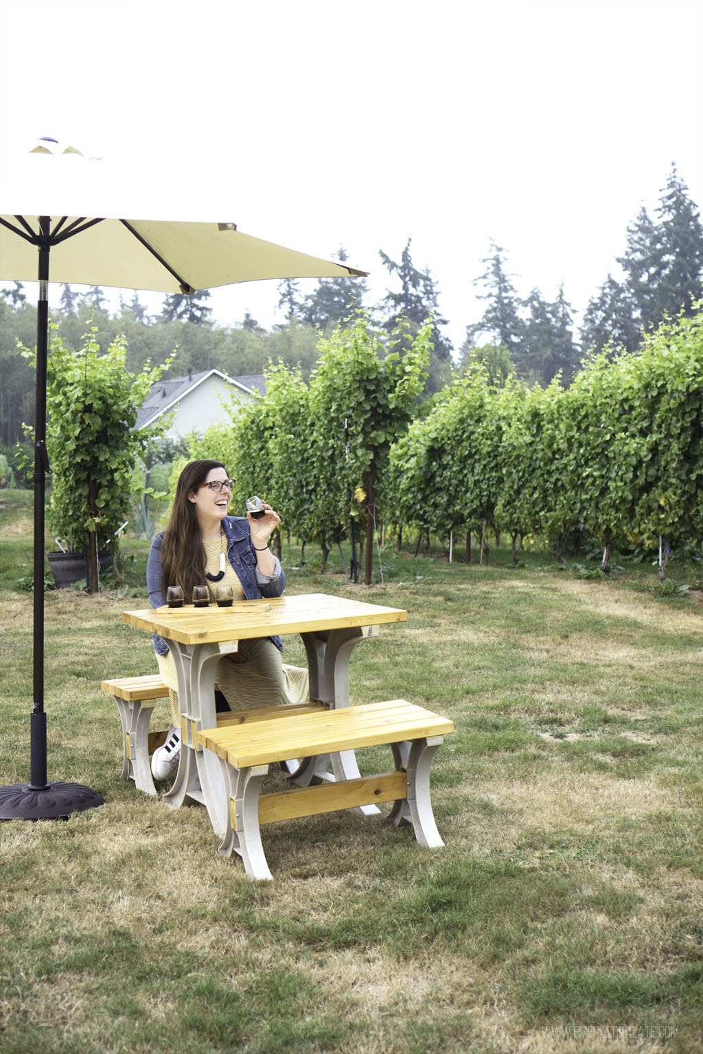 woman drinking at Holmes Harbor Cellars, one of the best Whidbey Island wineries