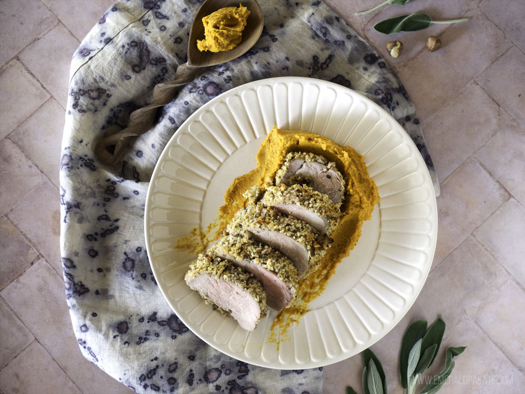 butternut squash and carrot mash plated with pork tenderloin on top