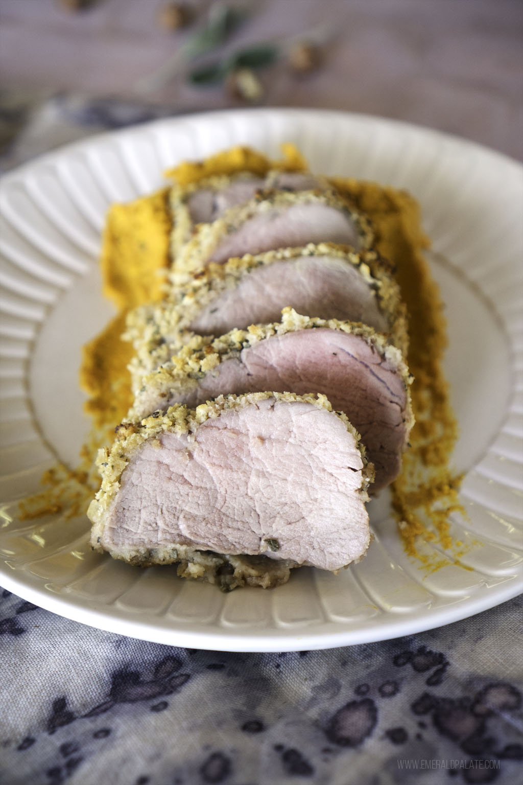 close up of sliced pork tenderloin coated in a sage panko crust