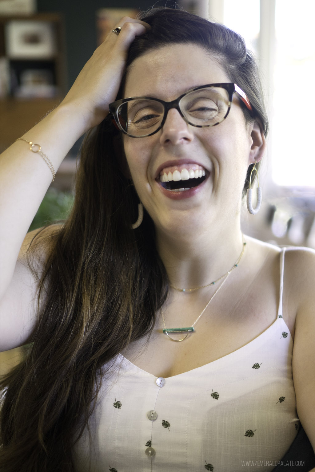 woman laughing wearing jewelry from Seattle, one of the best Seattle gifts online you can ship