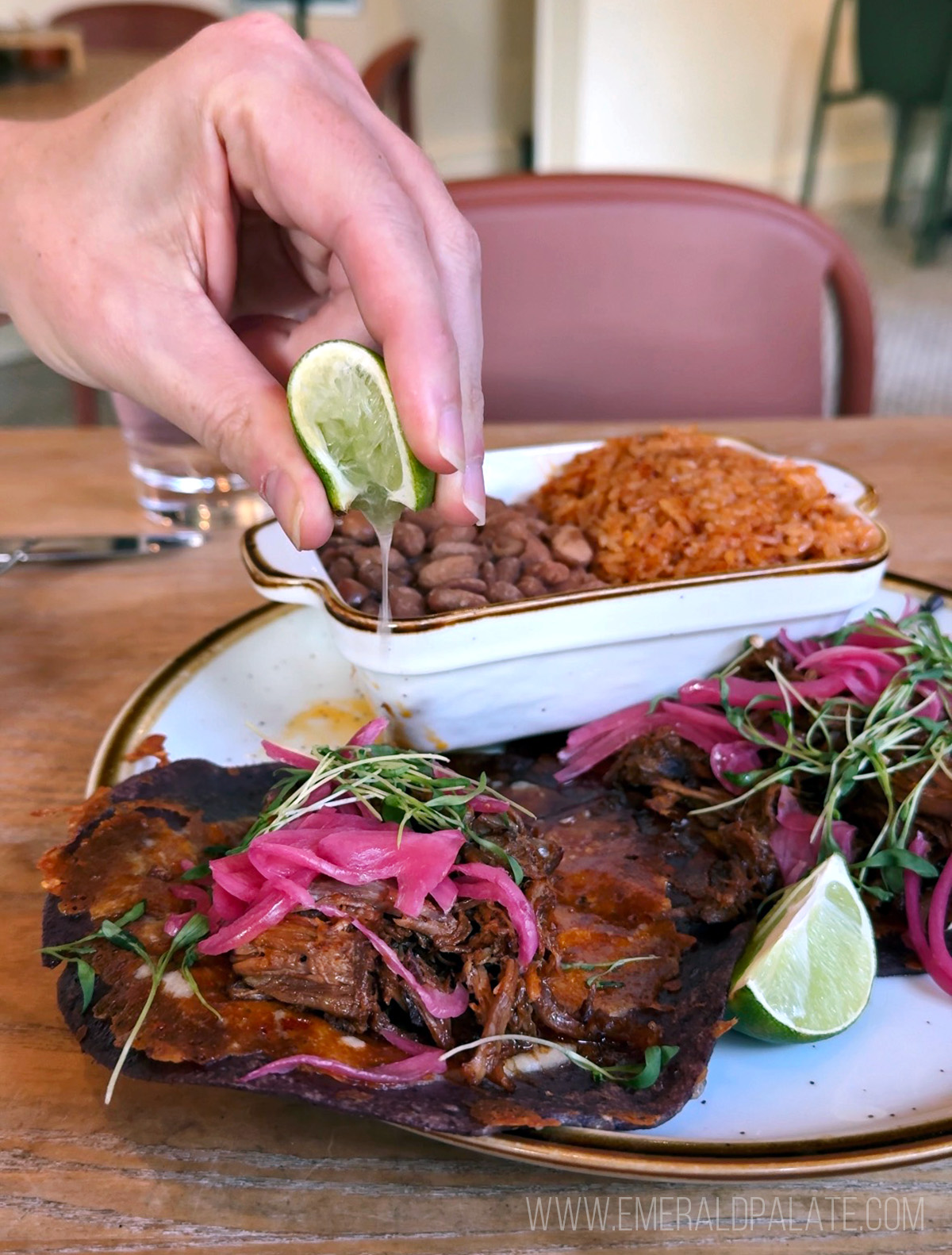 person squeezing lime over one of the best street tacos in Seattle