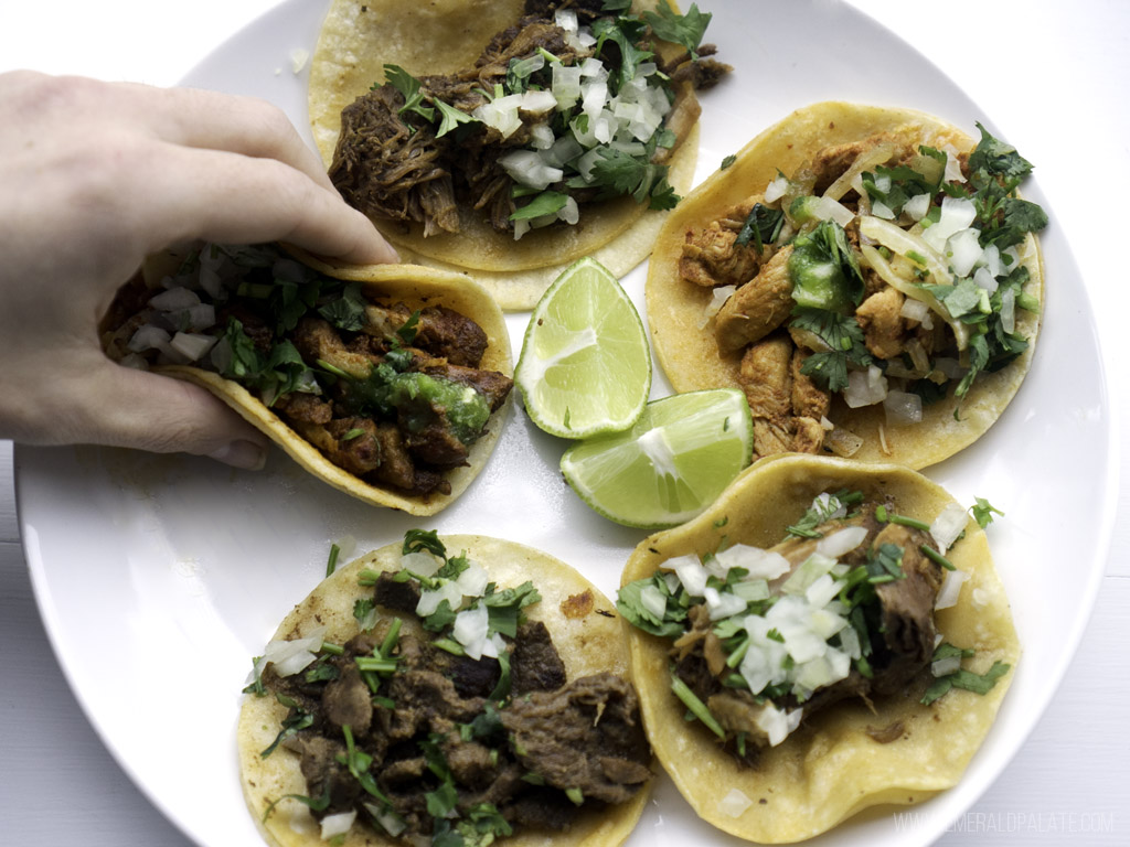 person picking up one of the best street tacos in Seattle