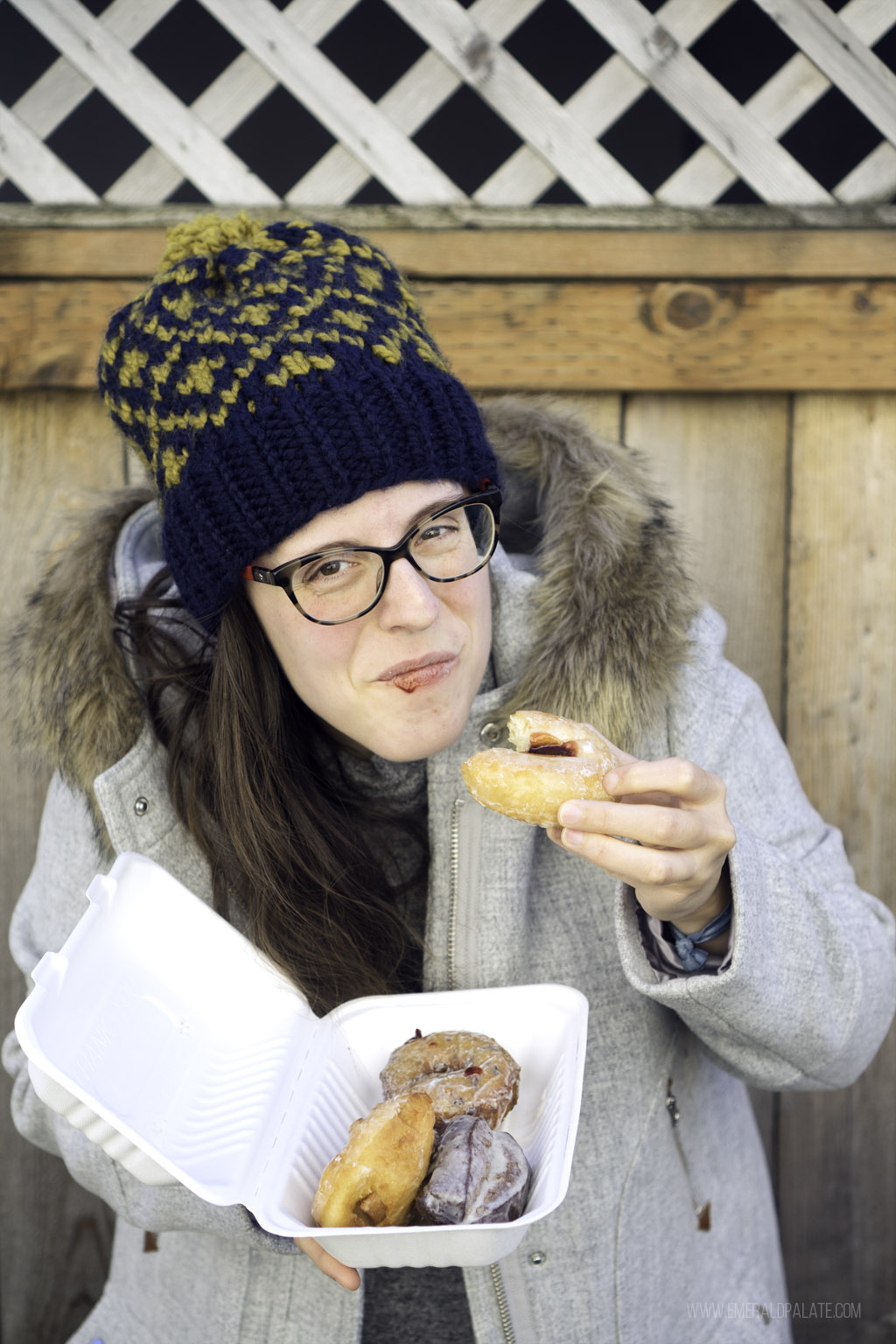 woman enjoying doughnuts from one of the best restaurants in West Seattle