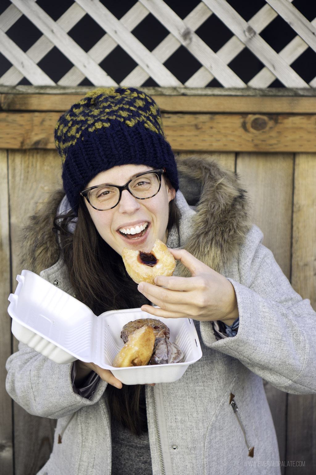 woman eating warm doughnuts in Seattle