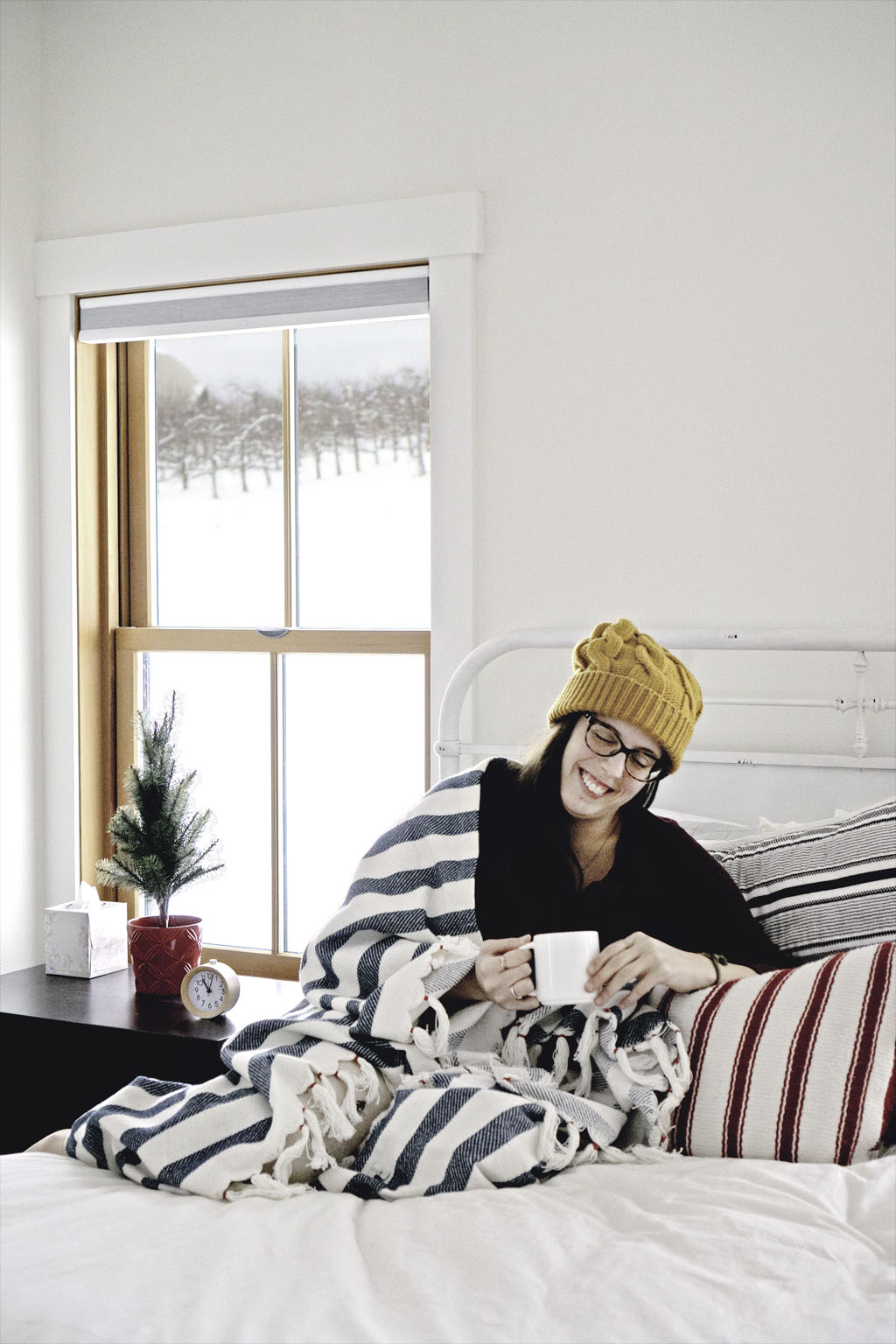 woman sitting in bed enjoying coffee