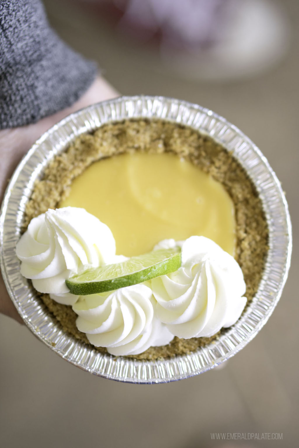 person holding mini key lime pie from dessert delivery in Seattle