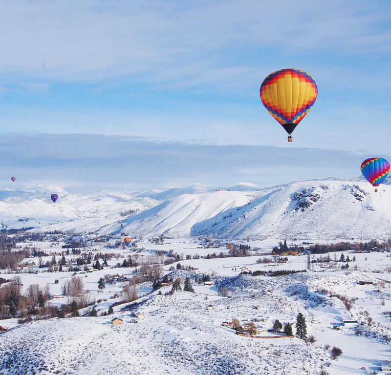 hot hair balloons over a winter landscape