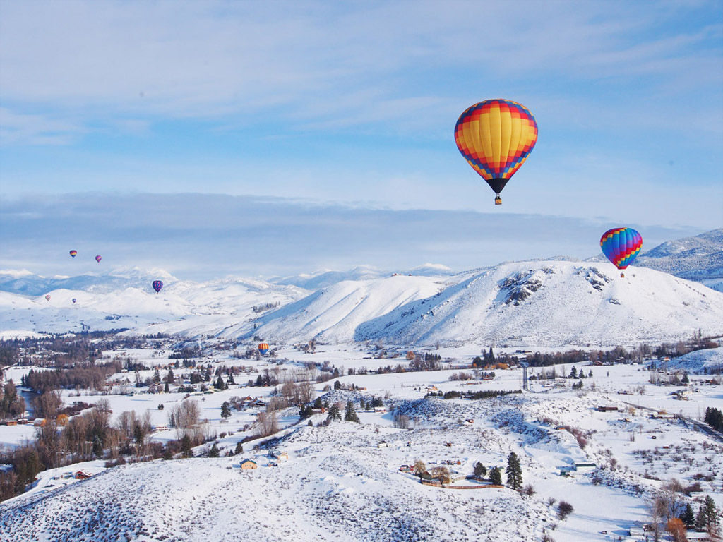 hot hair balloons over a winter landscape