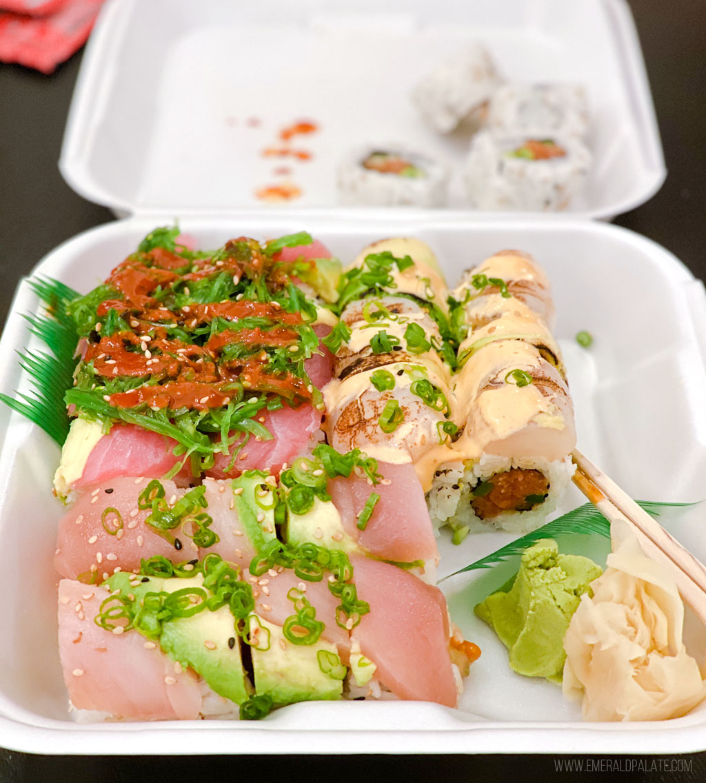 sushi rolls in a takeout container