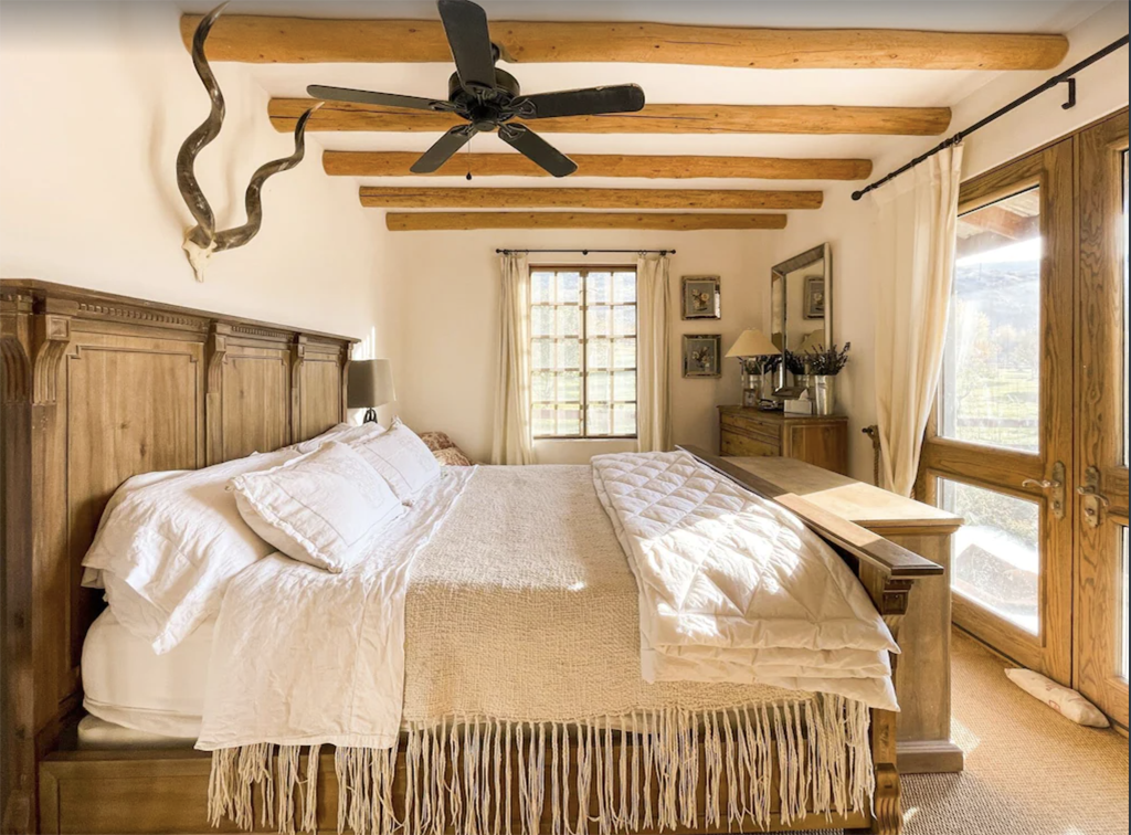 bedroom with beams and a lot of soothing tones at one of the best winter cabins in Washington state