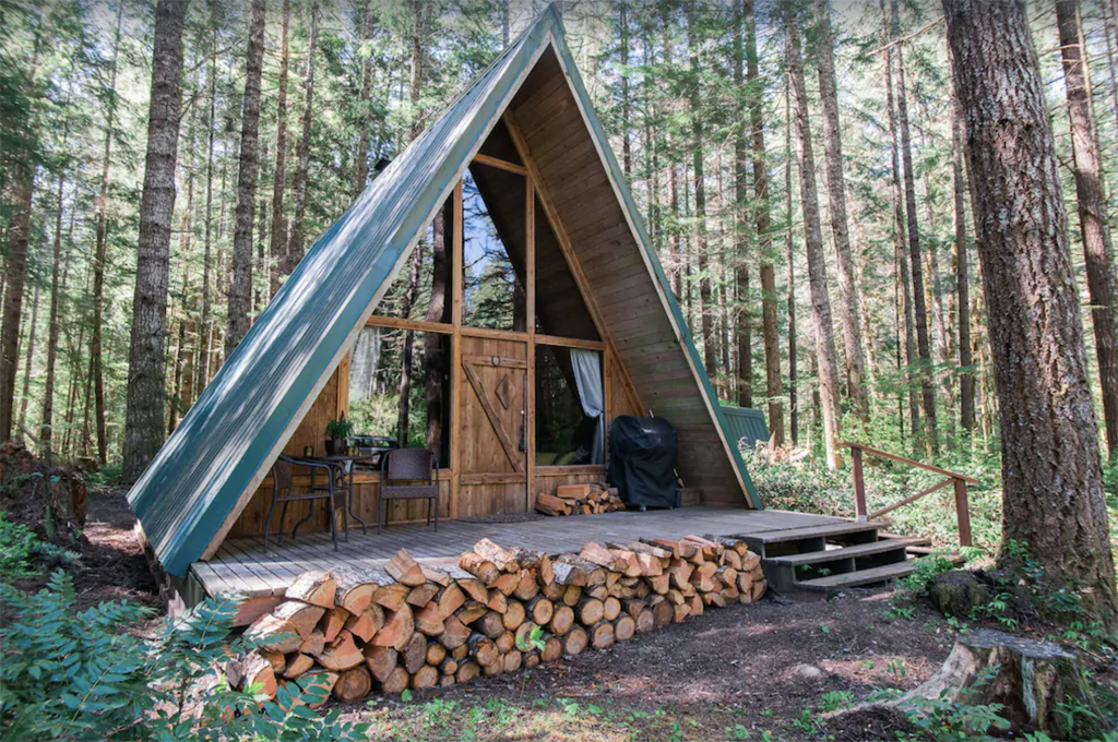 exterior of an a-frame cabin with wood outside