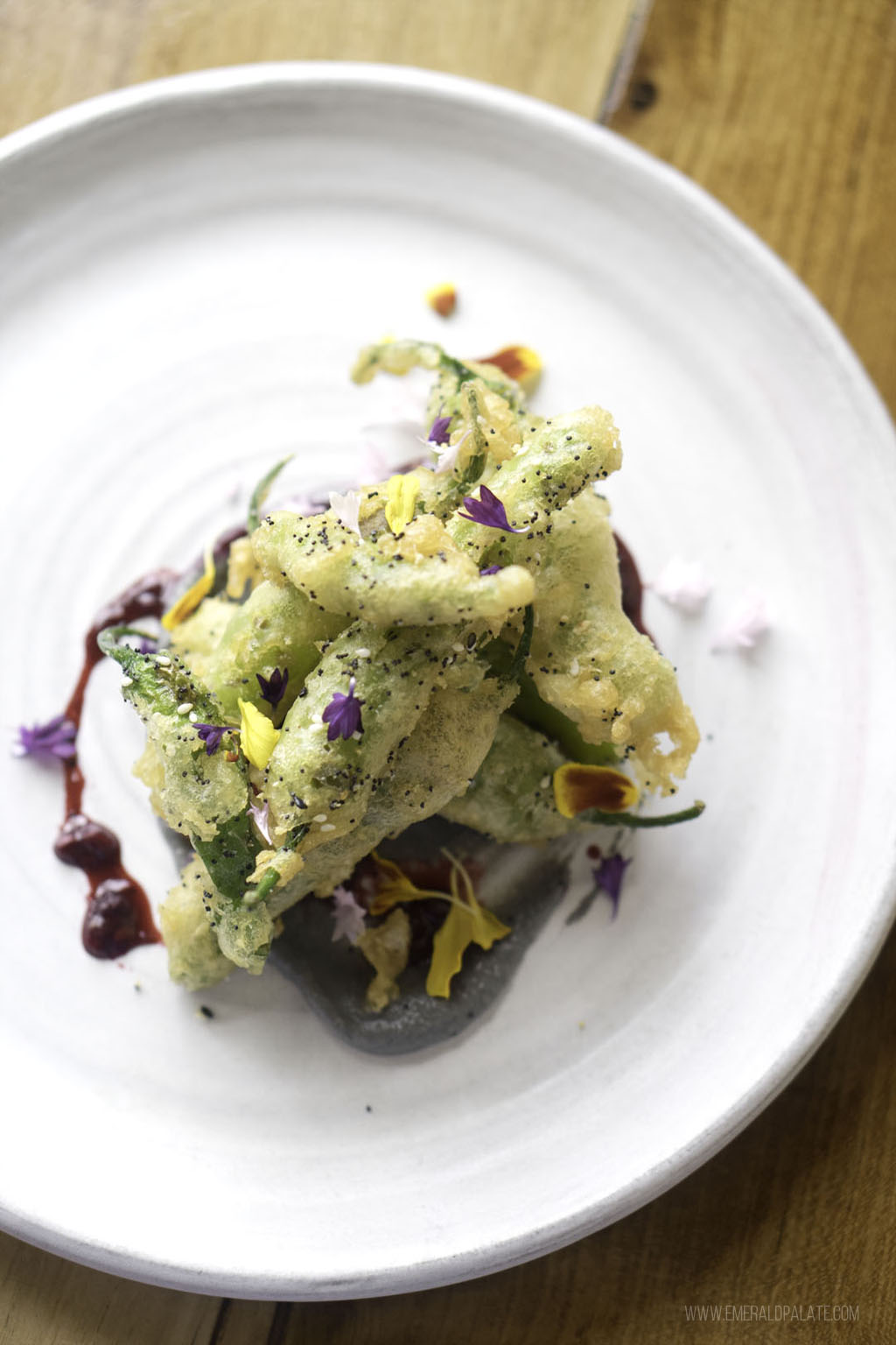 fried squash blossom on beautiful plate from a Seattle fine dining restaurant