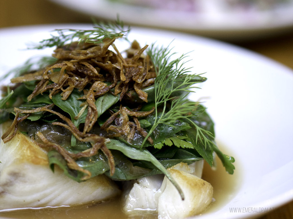 Close up of white fish heaping with herbs from a Fremont restaurant
