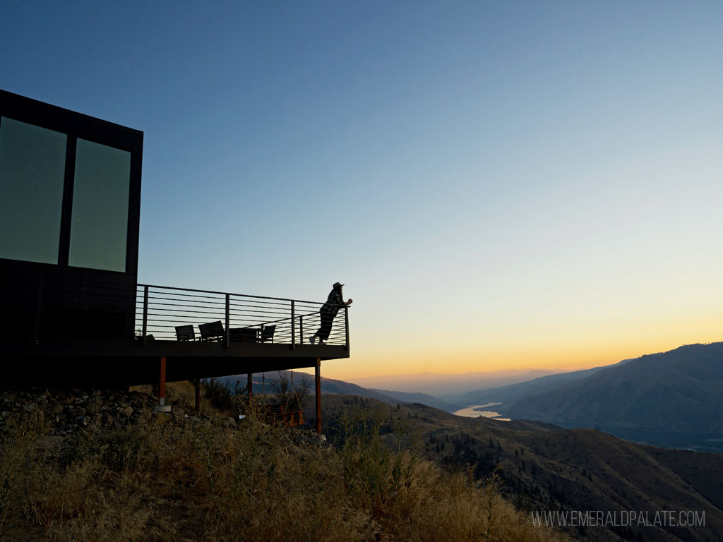 Woman overlooking valley on a balcony of a romantic Airbnb in Washington State