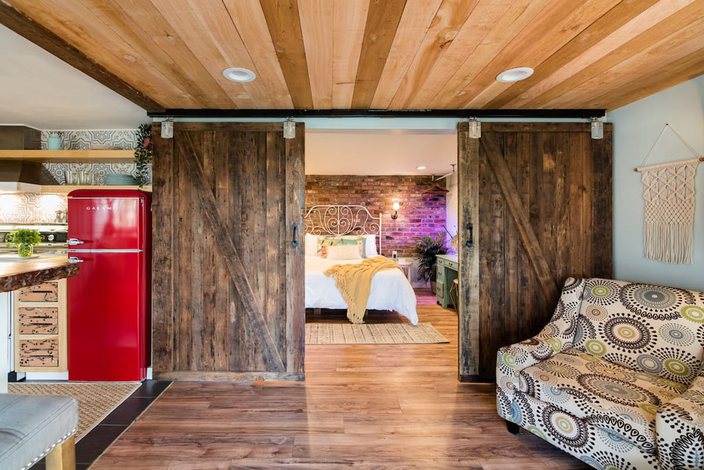 sliding barn doors into bedroom of romantic airbnb Washington state