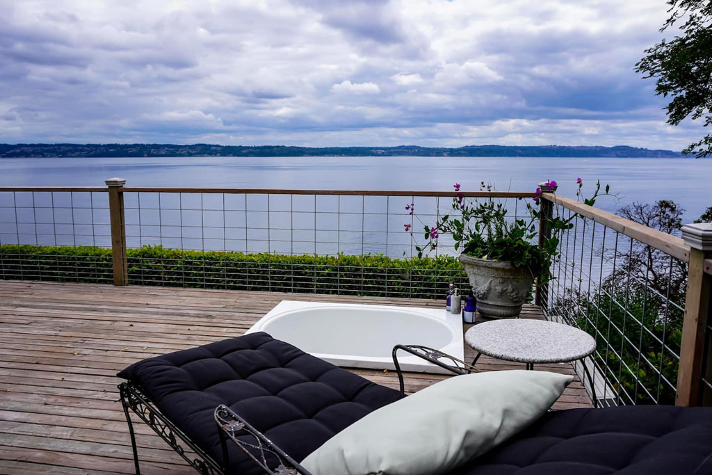 deck with hot tub overlooking watering, a perfect airbnb for couples