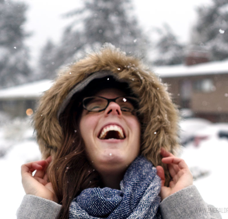 woman laughing in the snow