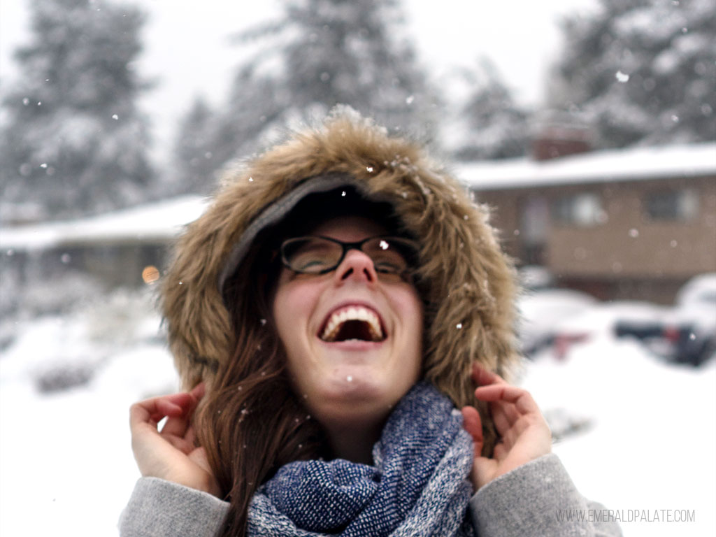 woman laughing in the snow