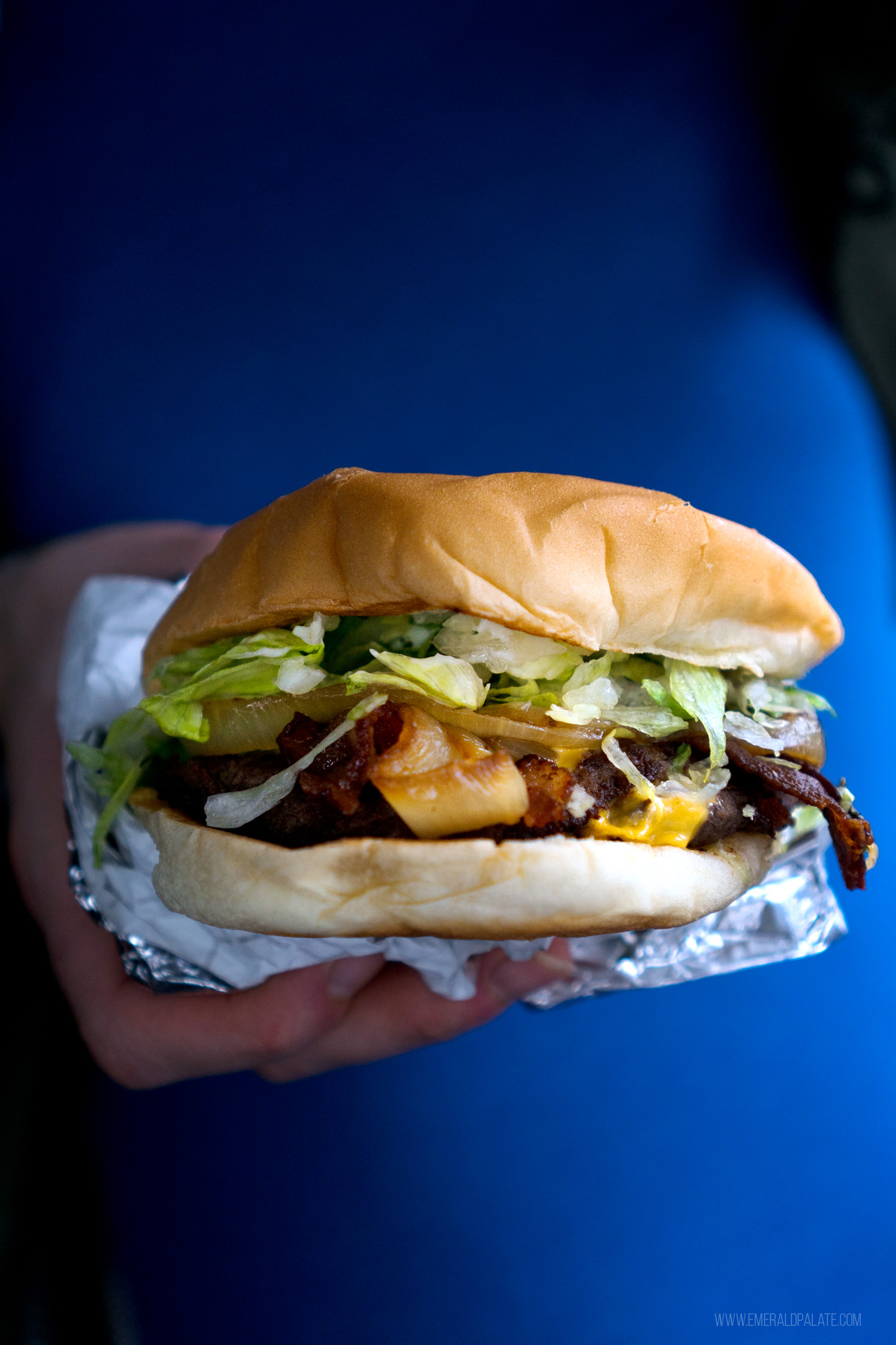 person holding one of the top Seattle burgers
