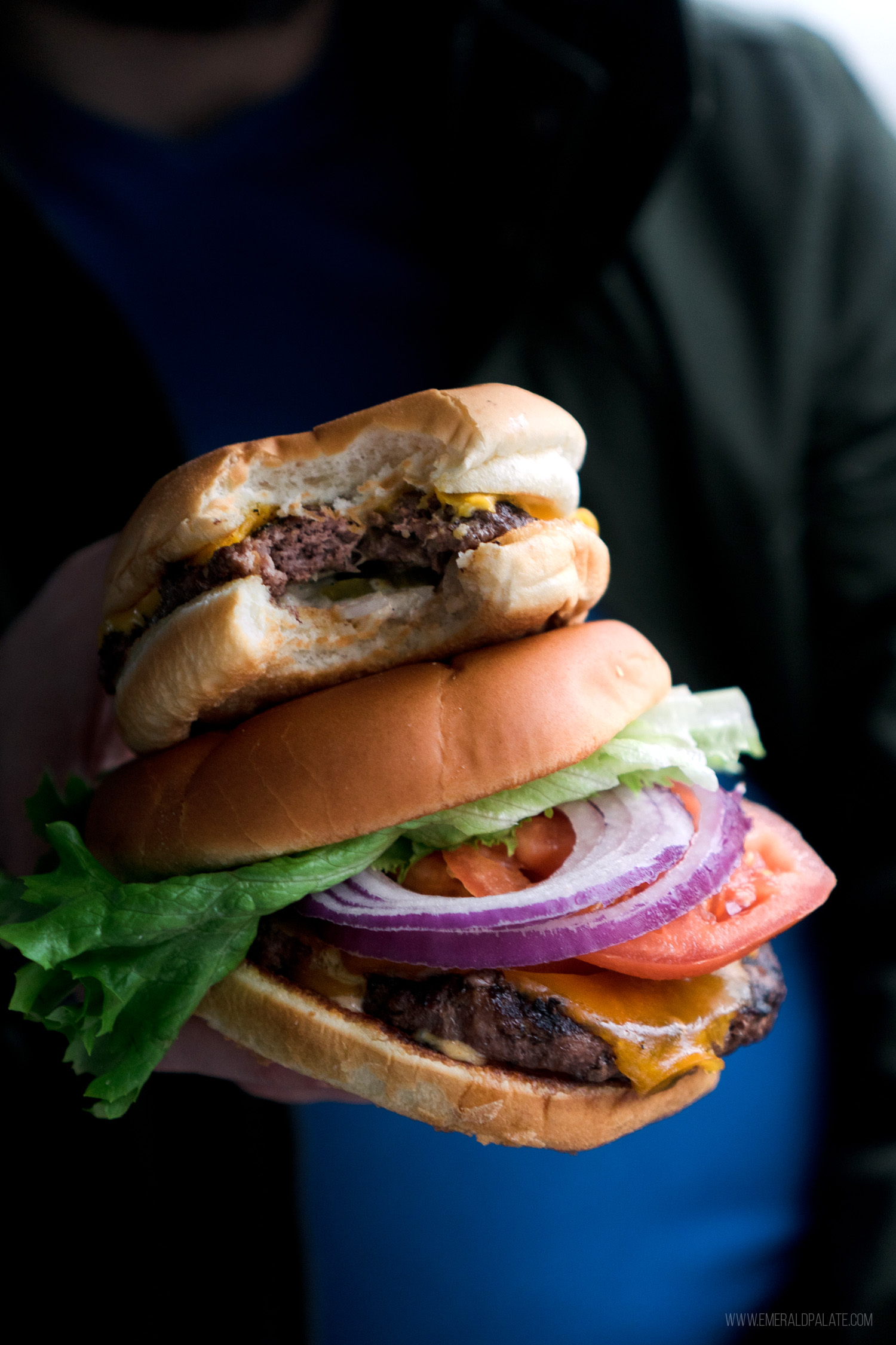 a drive-in style burger and gourmet burger in Seattle stacked on top of each other