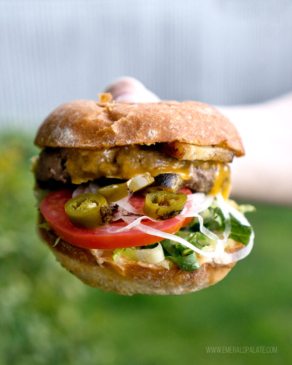 person holding big burger