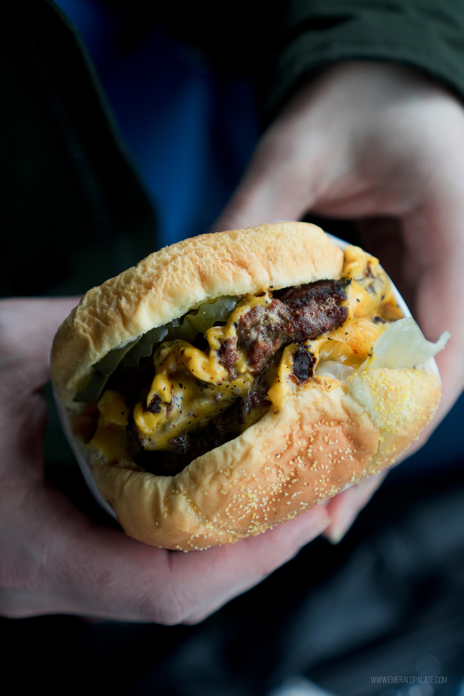 person holding one of the best Seattle burgers