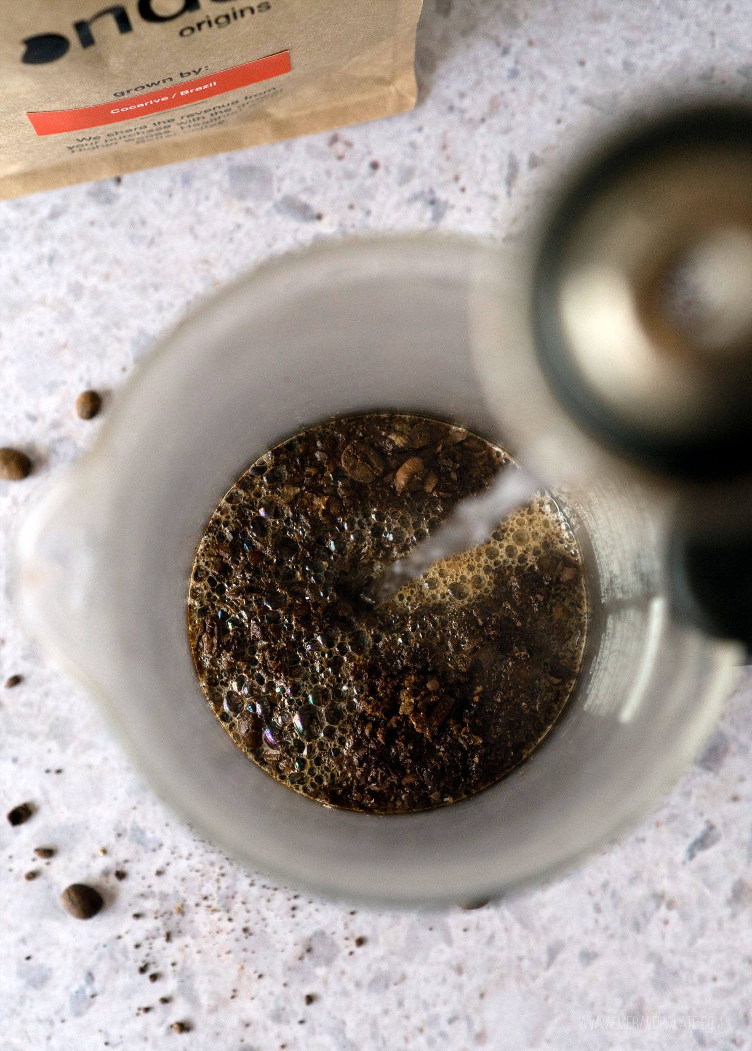 close up of person pouring boiling water into a French press