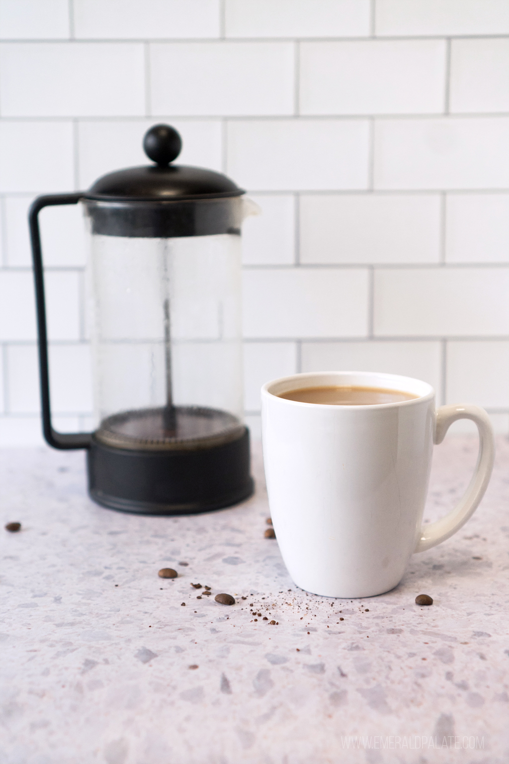 cup of coffee next to a French press