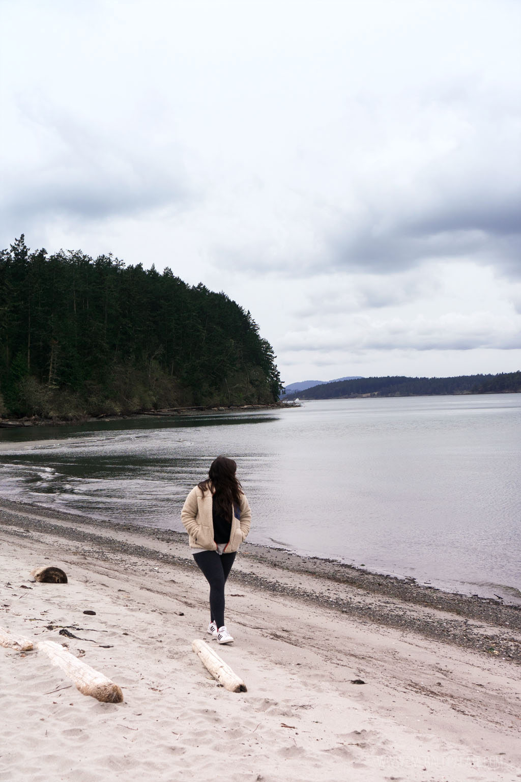 woman walking on beach at Odlin County Park on Lopez Island