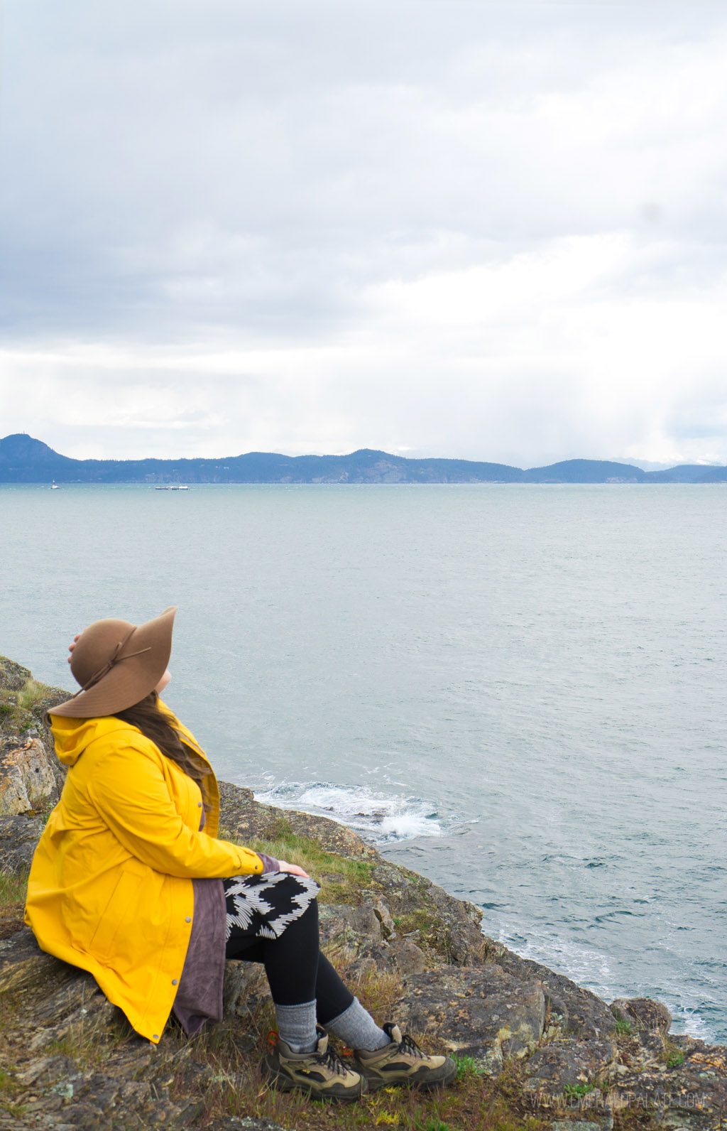 woman overlooking water on cliff on Lopez Island, WA