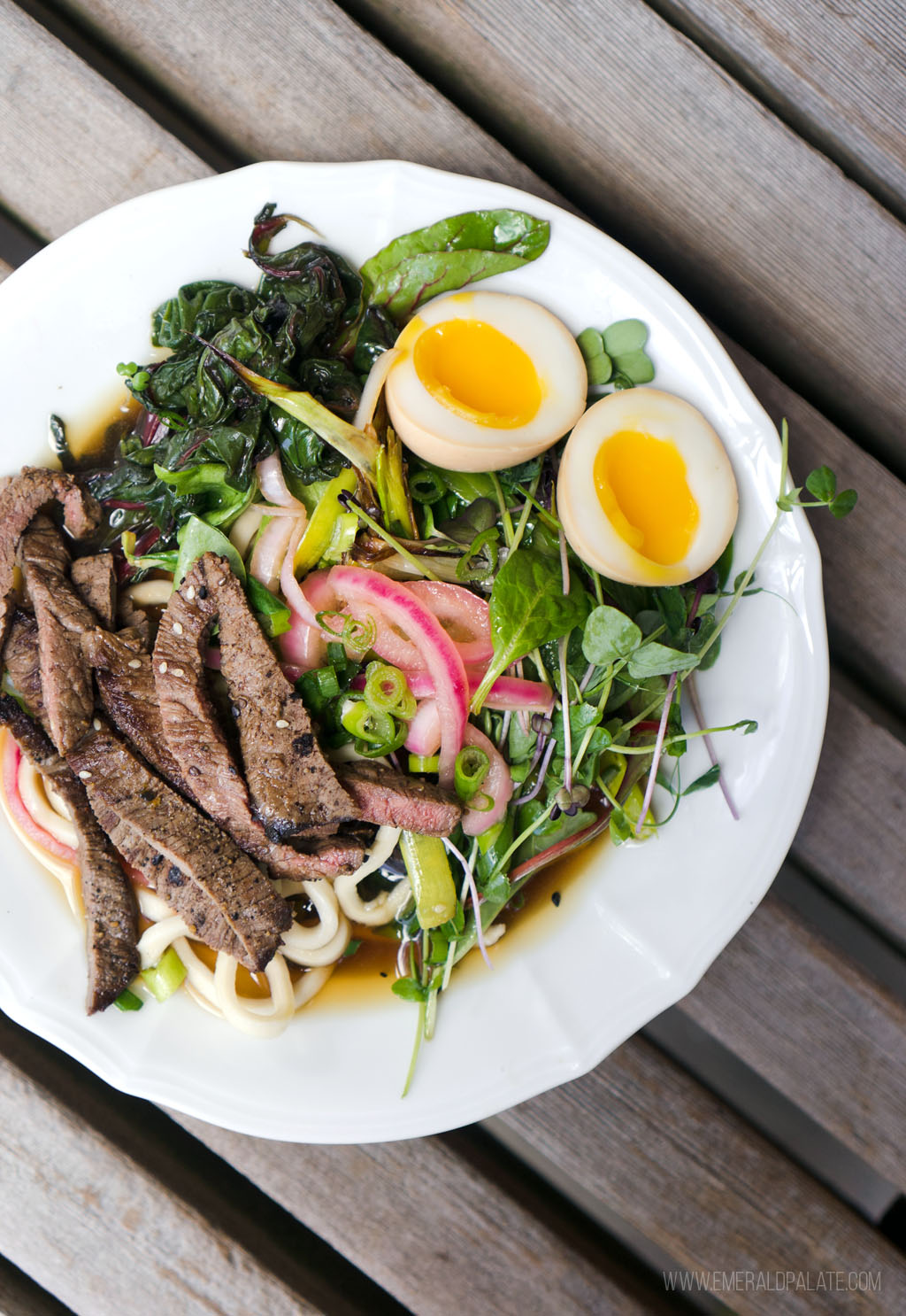 bowl of udon noodles with beef, greens, pickled onions, and runny eggs from a restaurant on Lopez Island, WA