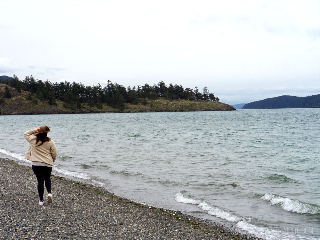 woman walking on beach at Spencer Spit State Park, one of the best things to do on Lopez Island