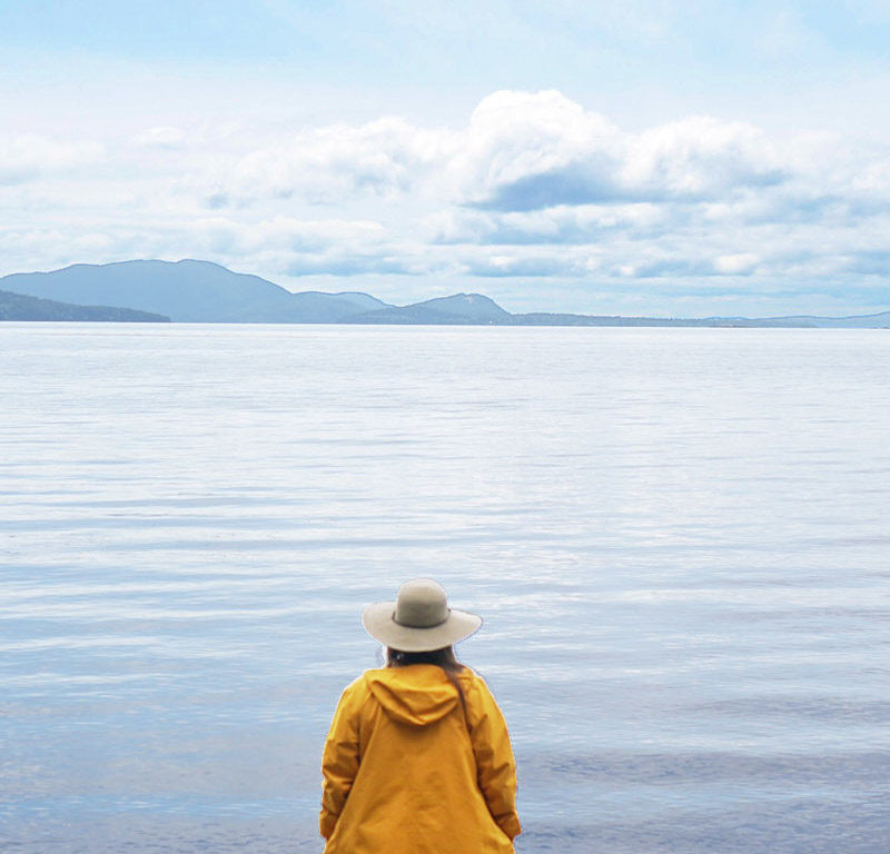 woman standing in Larrabee State Park, a thing to do according to the ultimate Bellingham guide