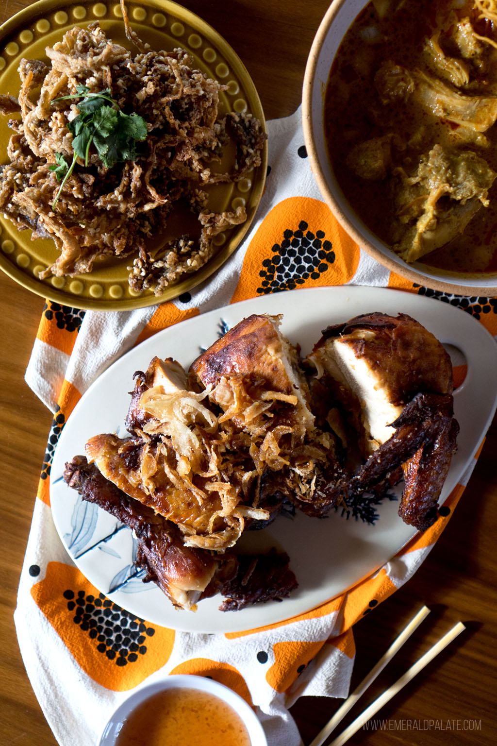 plate of Thai food like fried chicken, crispy mushrooms, and khao soi from a restaurant in Seattle